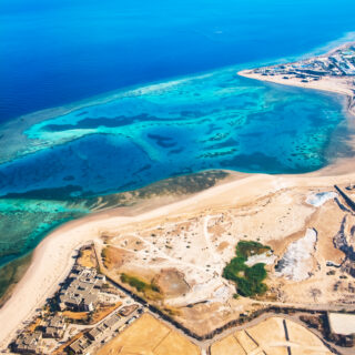 Beautiful view on reefs and hotels from plane window on the coast of the Red Sea in SHARM EL SHEIKH, Egypt. Travel concept